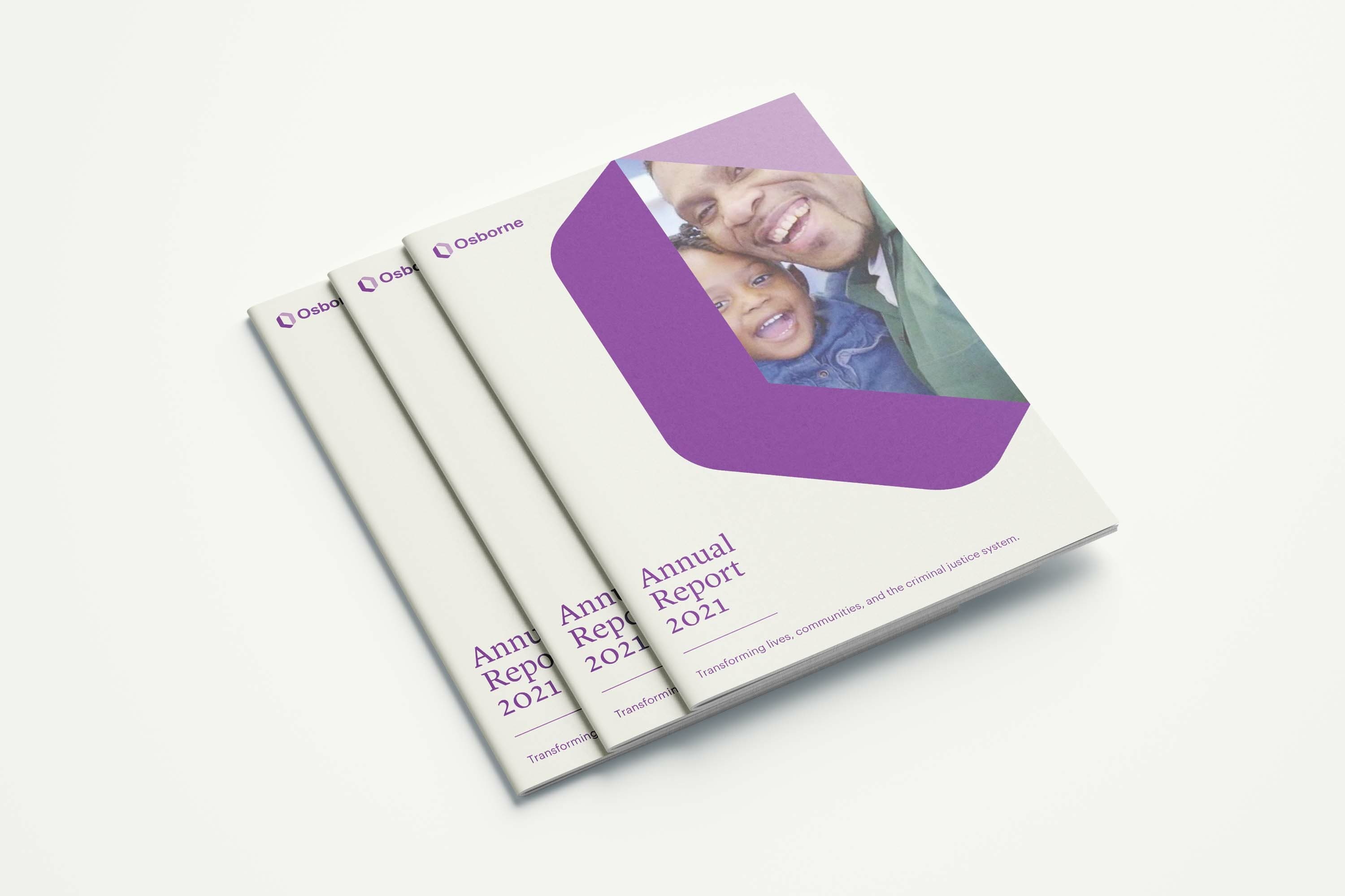 Three copies of a booklet titled “Annual Report 2021” with a purple cover design featuring a photo of a smiling adult and child. The booklet is from Osborne, marked with a tagline: "Transforming lives, communities, and the criminal justice system.