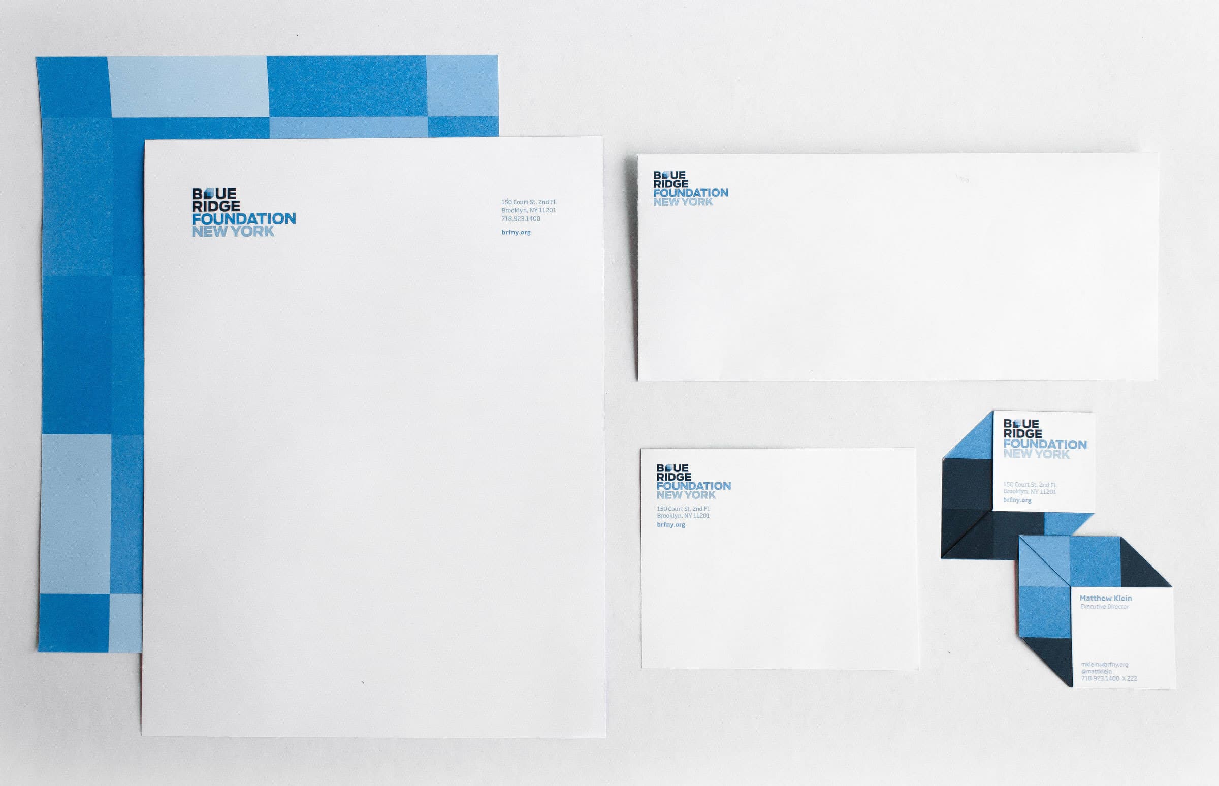 A set of stationery items including two letterheads, an envelope, two business cards, and three folded note cards. All items have a blue and white color scheme with the "Blue Ridge Foundation New York" logo on them.
