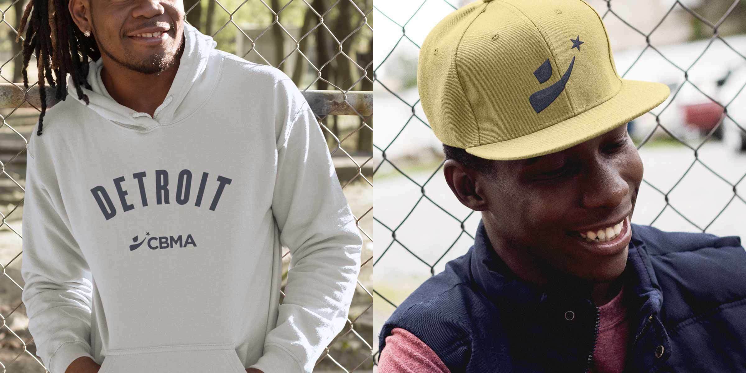A split image of two people smiling. The left person, against a rural backdrop, wears a light gray hoodie with "DETROIT" and "CBMA" written on it. The right person, in an urban setting, wears a yellow cap with a logo and a dark vest. Both seem relaxed and happy.