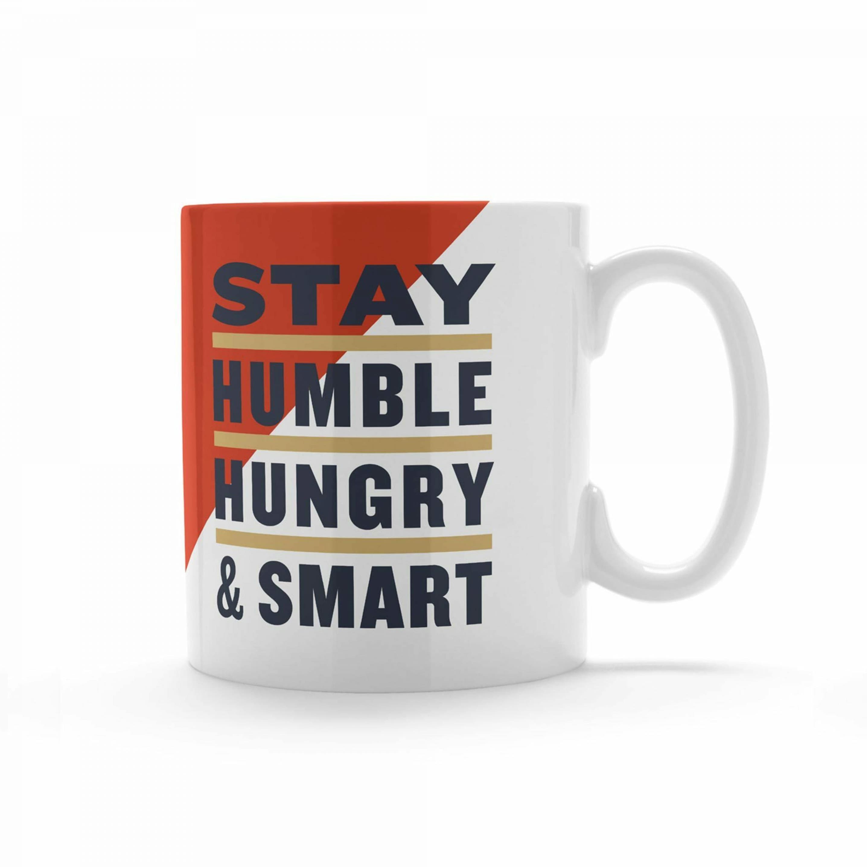 A white ceramic mug with a handle on the right side featuring a design with a red and white diagonal split. The text "Stay Humble Hungry & Smart" is written in bold, with "Humble," "Hungry," and "& Smart" in gold, red, and blue, respectively.