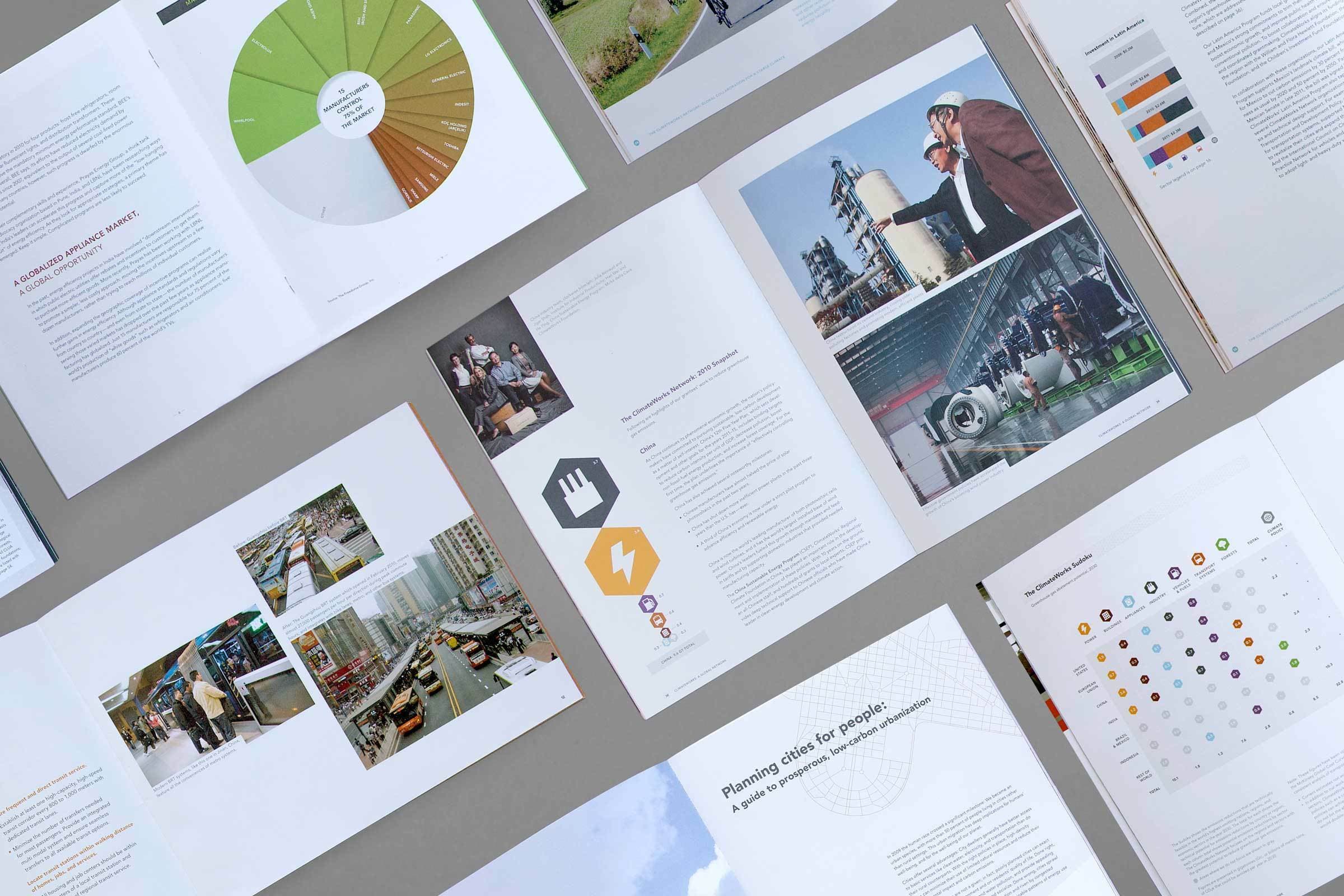 A collection of opened magazines and brochures lays on a surface. They display graphs, charts, text, and photographs of urban scenes, industrial settings, and people in professional environments. The documents are arranged in various orientations, showcasing diverse content.