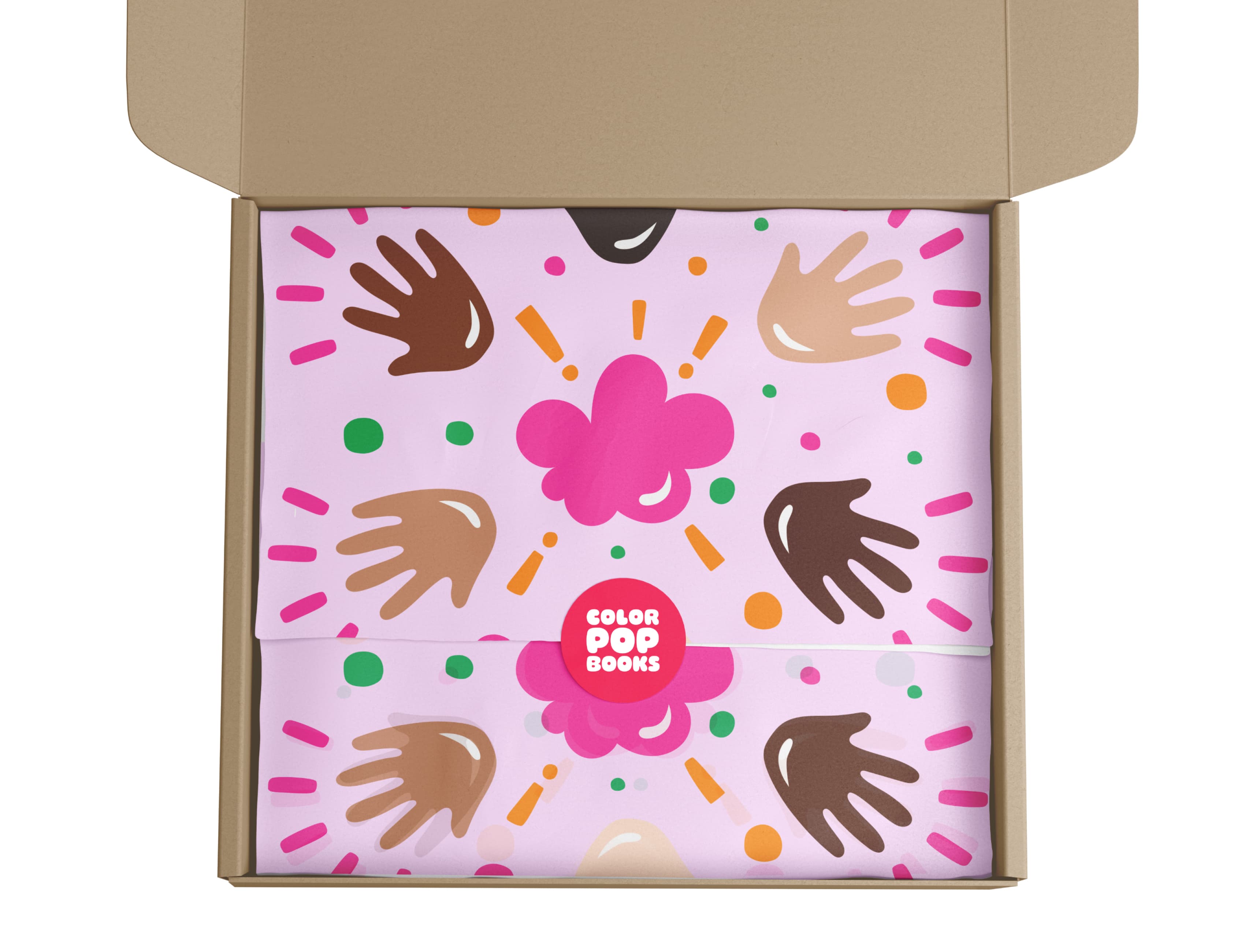A cardboard box is open to reveal a Color Pop Books package inside. The package features a vibrant design of multicolored handprints and abstract shapes on a pink background. The Color Pop Books logo is visible in the center, printed on the packaging.