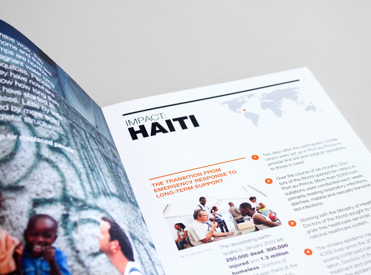 A magazine or brochure open to a page titled "Impact: Haiti." The page features a map highlighting Haiti's location, text detailing emergency response efforts, and photographs of people engaged in relief activities. The left side of the image shows part of another page with blurred content.
