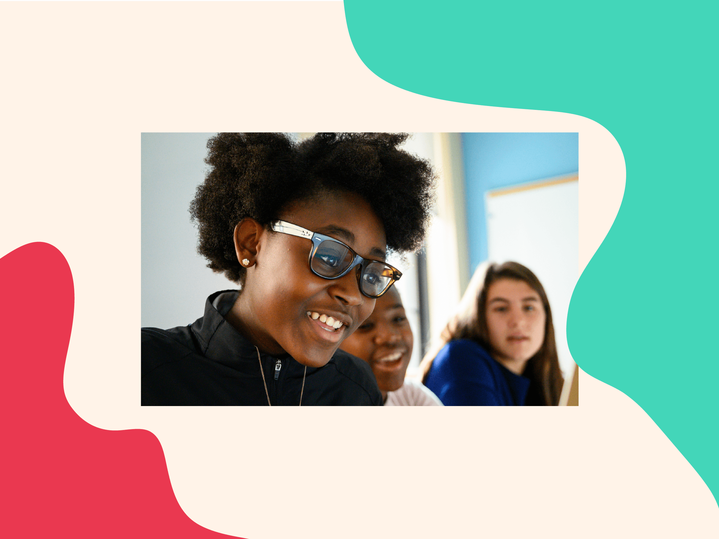 Three smiling girls are seated and engaged in conversation. The girl in the foreground has curly hair and wears glasses, while the girl beside her is partly visible, and the third girl, with straight hair, is looking forward. The background features a colorful, abstract design.