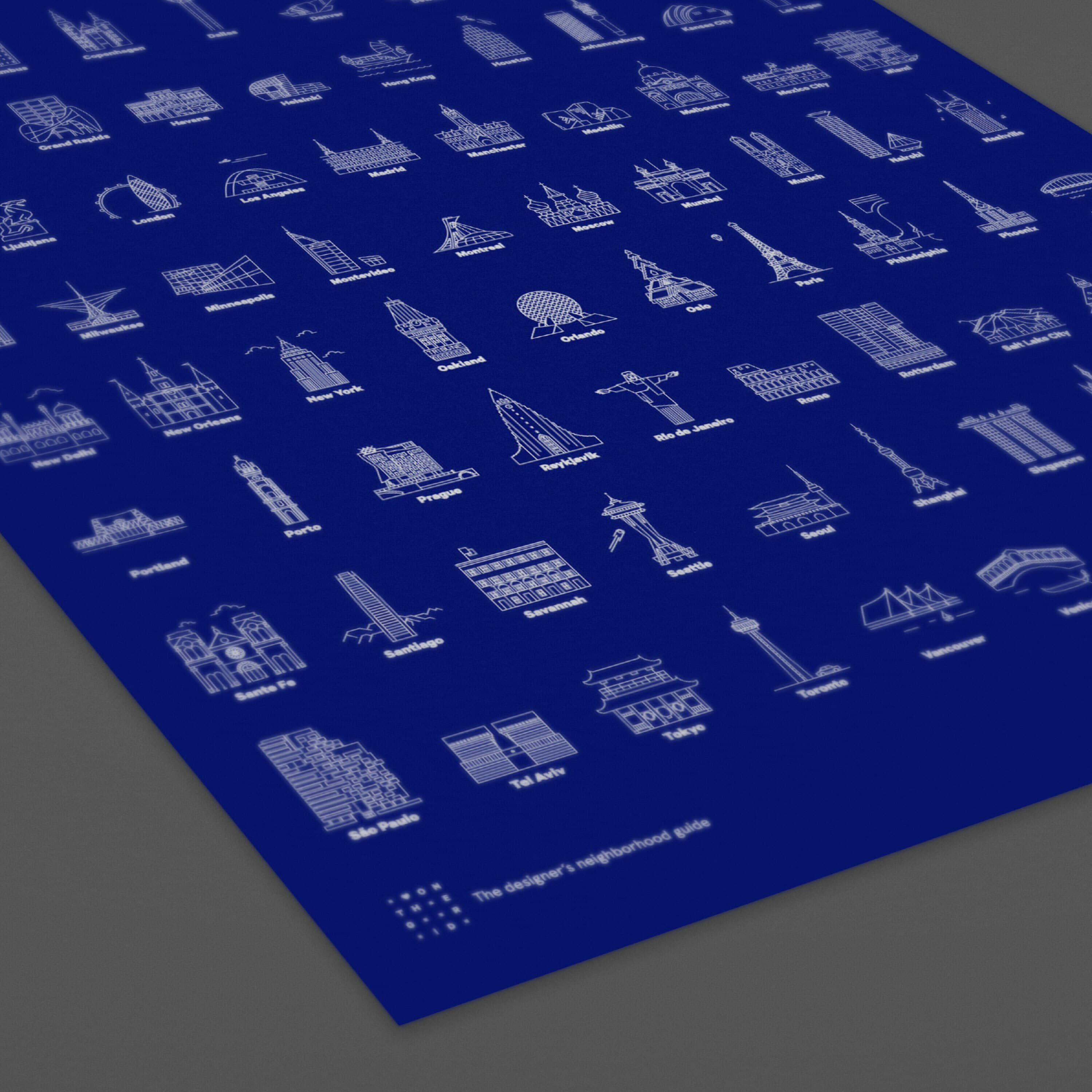 A blue poster with white outlined illustrations of various iconic buildings and landmarks from cities around the world. The buildings are arranged in a grid pattern, each with the name of the city listed underneath, such as New York, Paris, Tokyo, and Sydney.