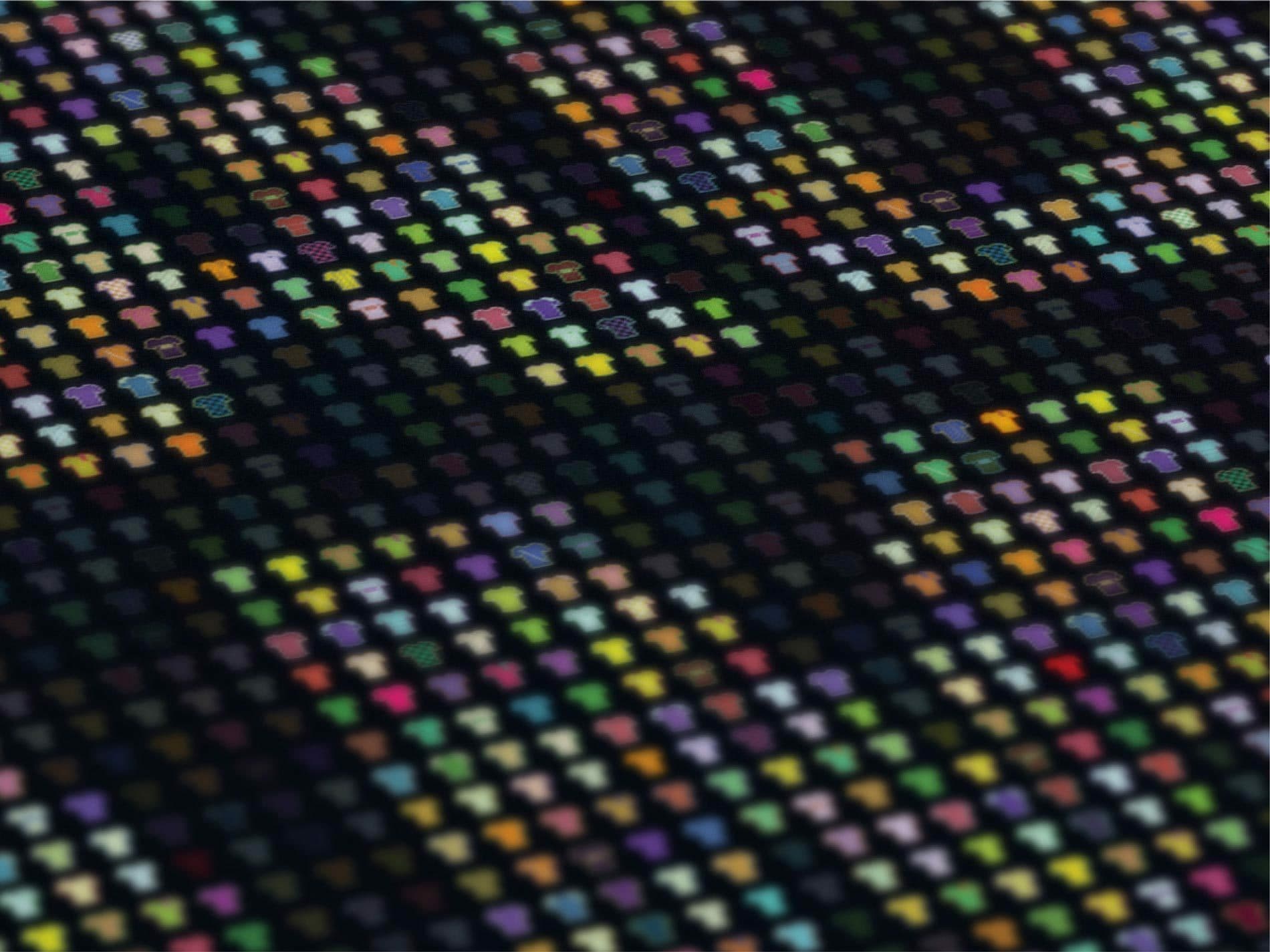 A close-up image of a pixelated pattern featuring tiny multicolored t-shirt icons arranged in a grid on a dark background. The t-shirts form various geometric shapes and give the impression of a digital, abstract design.