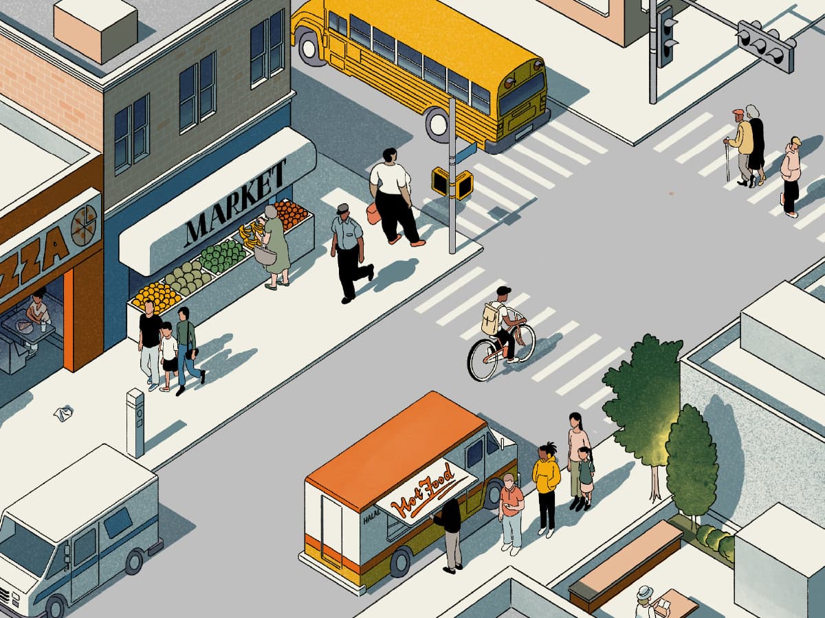 An isometric illustration of a city intersection includes a yellow school bus, pedestrians crossing the street, a market with fruits and vegetables, a pizza shop, a cyclist, and a food truck with "Hot Food" written on it. Trees and buildings surround the area.