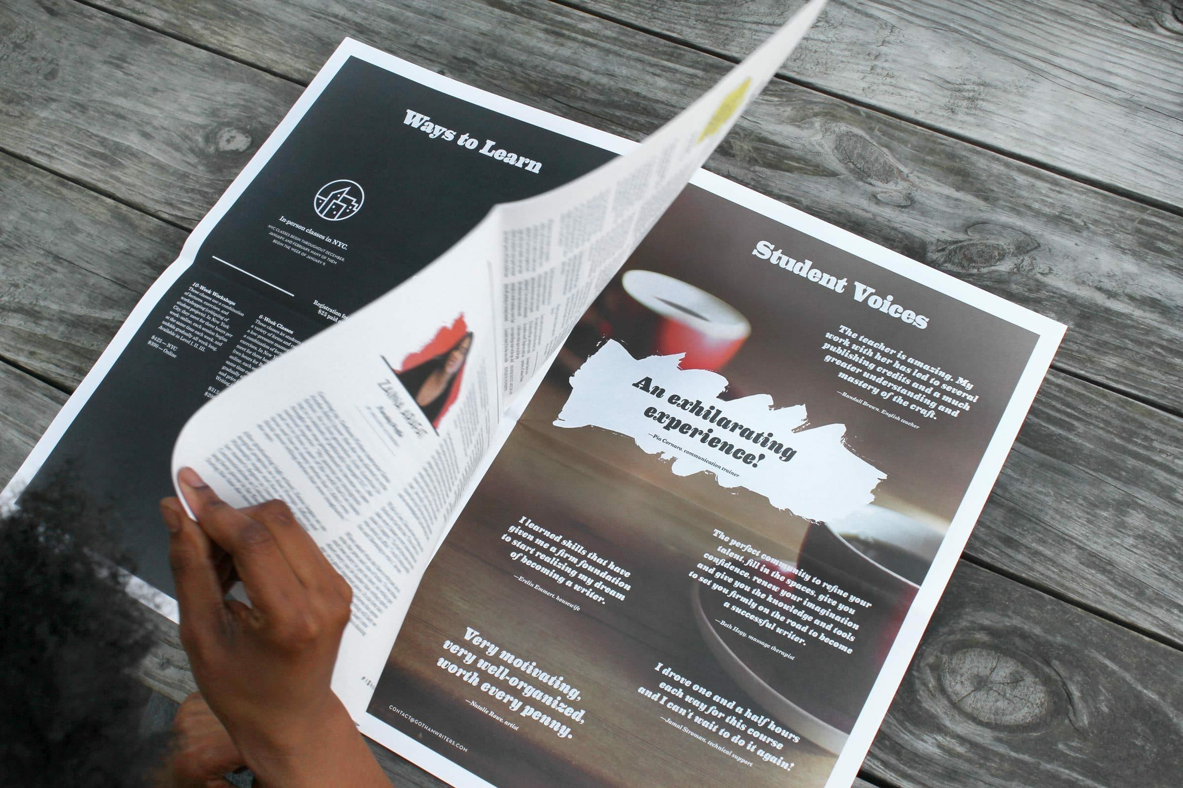 A person is flipping through a magazine, showcasing an article titled "Student Voices." The magazine is open on a wooden table, displaying various sections with text and images.