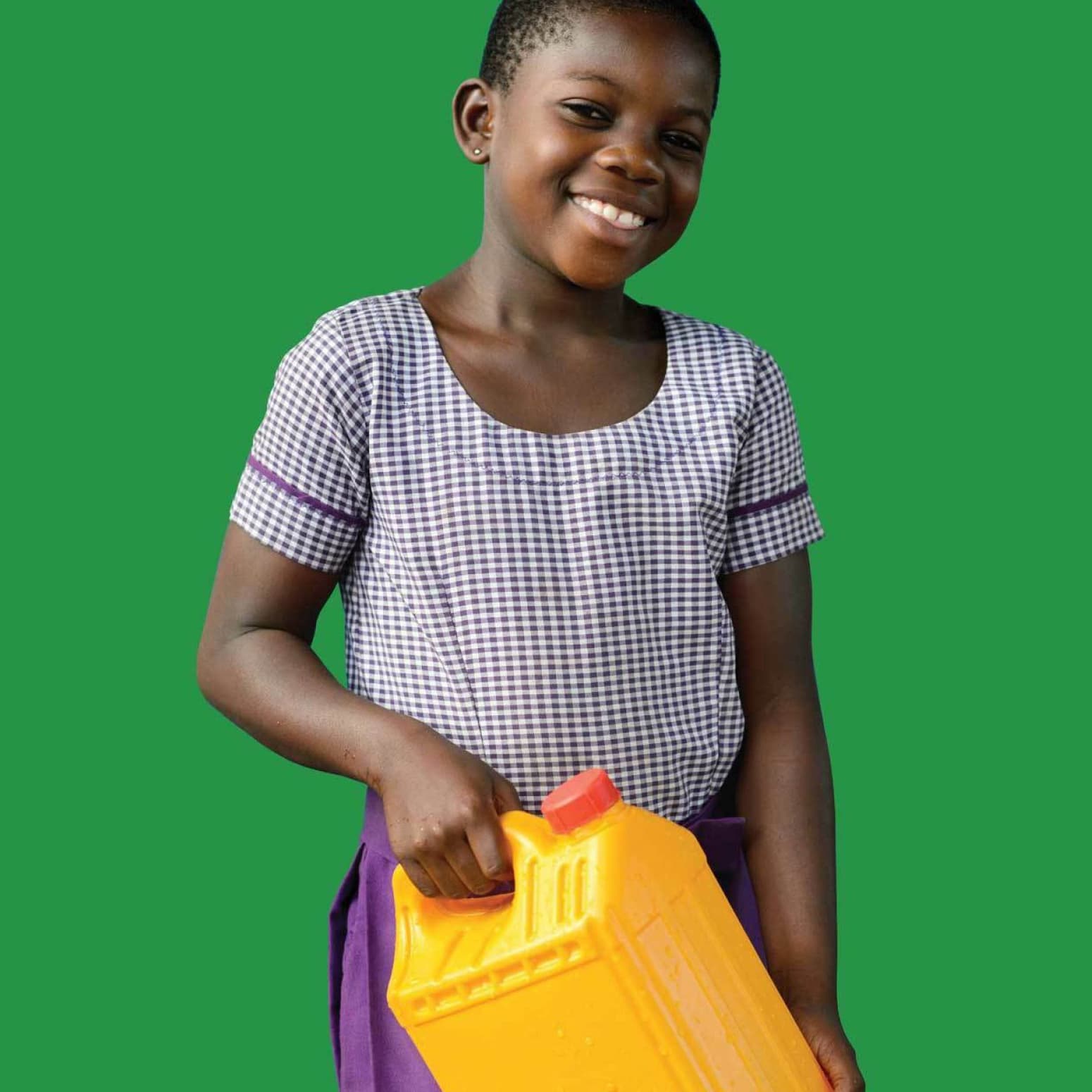 A smiling child, dressed in a checkered shirt and purple skirt, holds a yellow jerrycan with a red cap in one hand. The background is a solid green color.