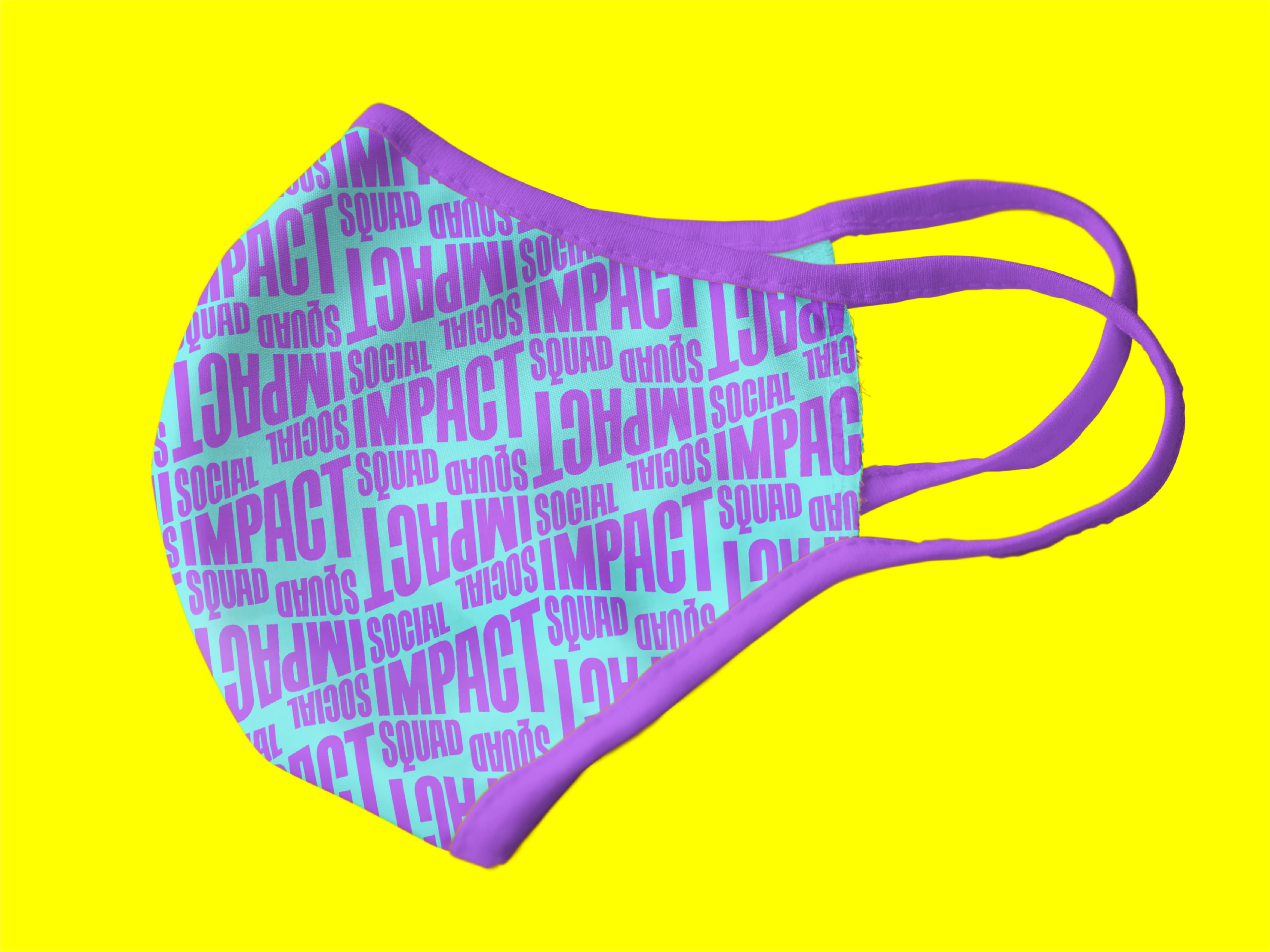 A purple face mask with the words "SOCIAL IMPACT" and "SQUAD" repeatedly printed in blue on a bright yellow background. The mask's ear loops and edges are also purple.
