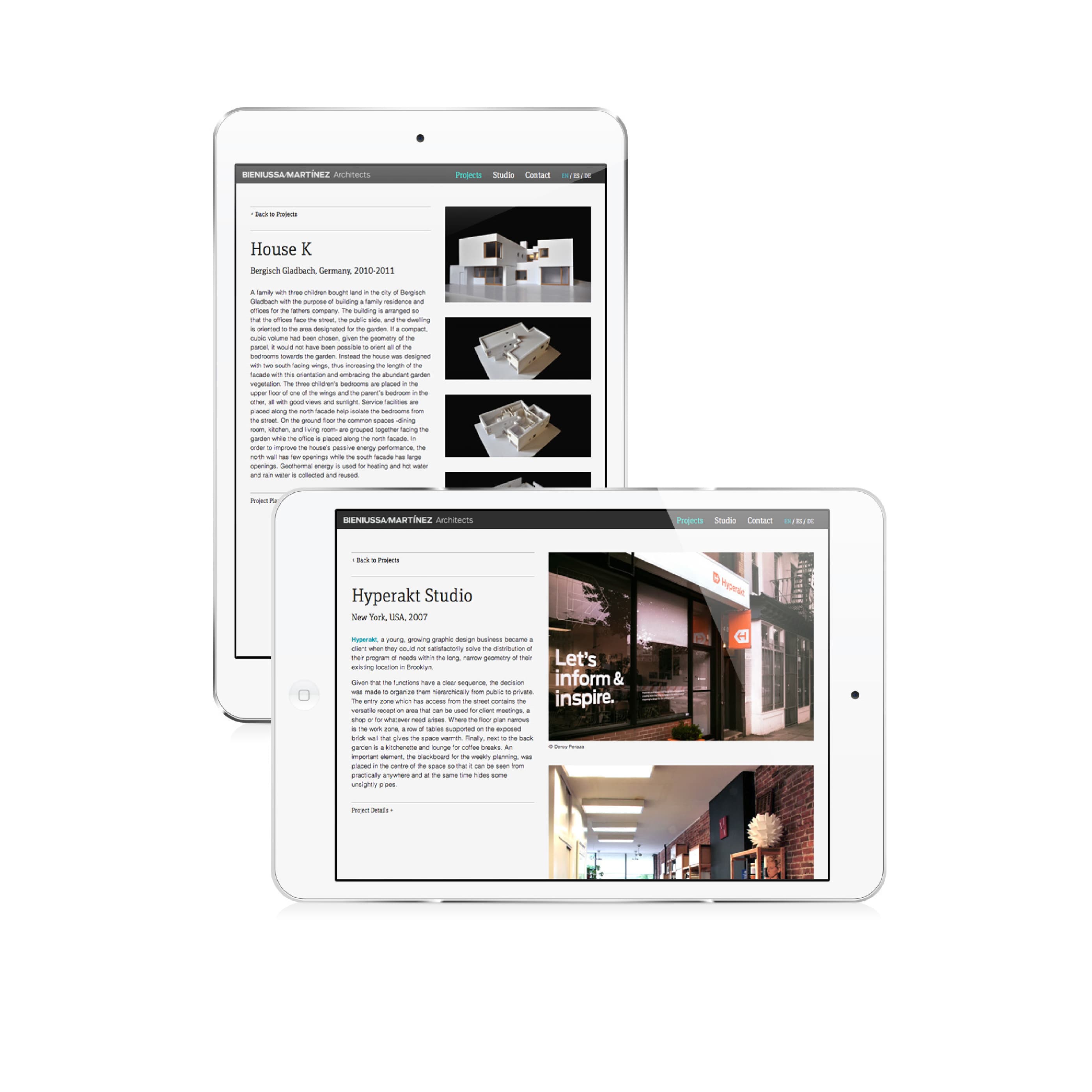 Two white tablets display architectural project information on their screens. The front tablet shows a studio project with text and images of modern interiors. The back tablet showcases details about a "House K" project with images of contemporary home designs.