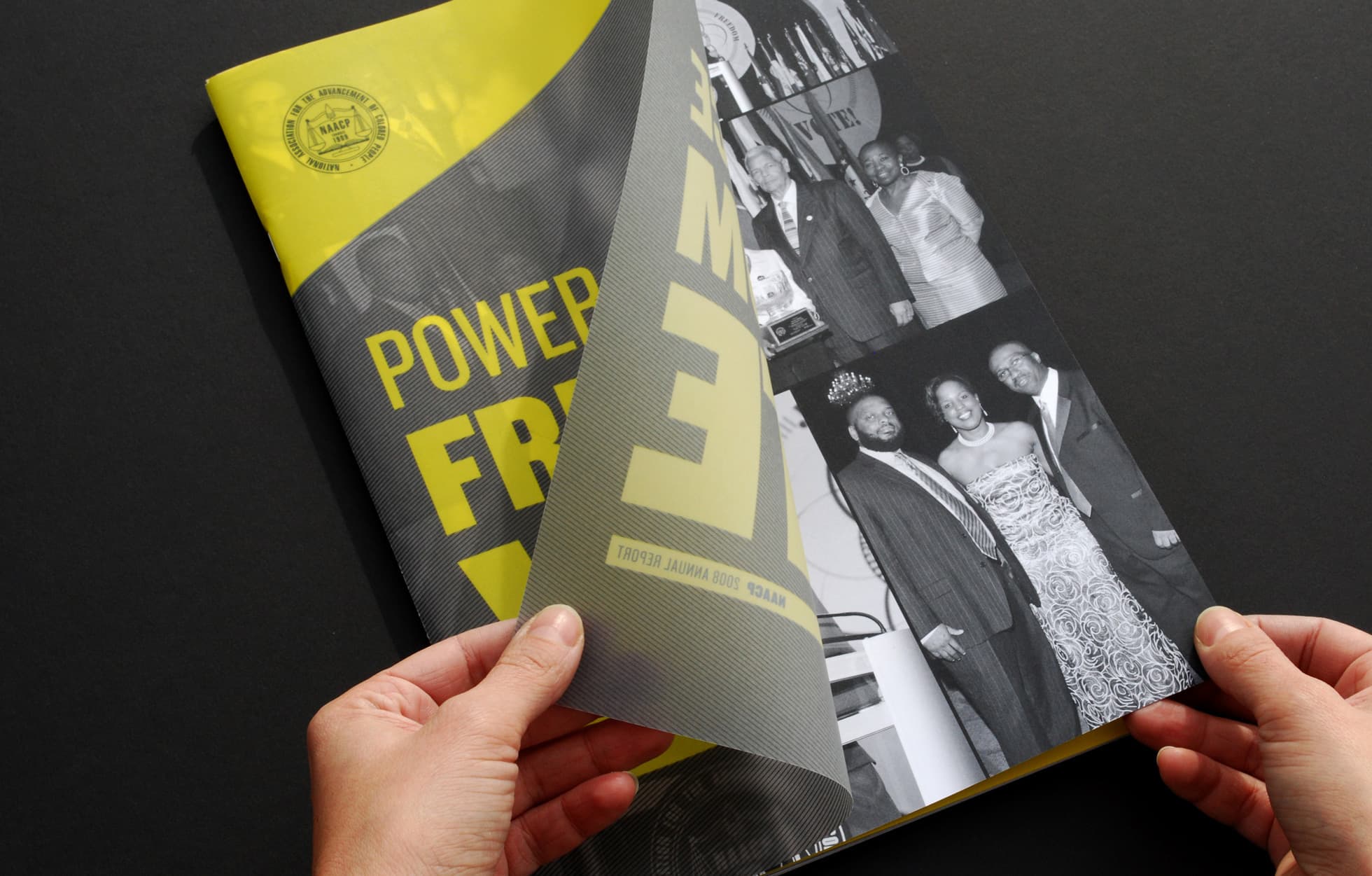 A person is flipping through a magazine with a yellow cover featuring the text "POWER FROM FAME." Visible on the page being flipped is a grayscale photo collage of people dressed formally at an event. The magazine has a sleek, modern design.