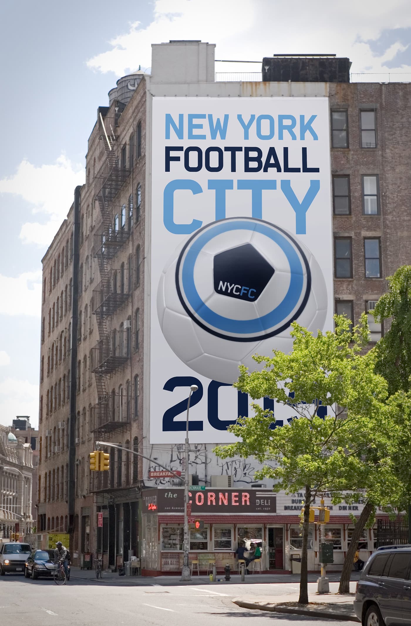 A large banner on the side of a building features the text "New York City Football Club 2015" with a soccer ball graphic and the NYCFC logo. The street below has shops with visible signs, and a few cars and pedestrians are present. Trees partially obscure the view.
