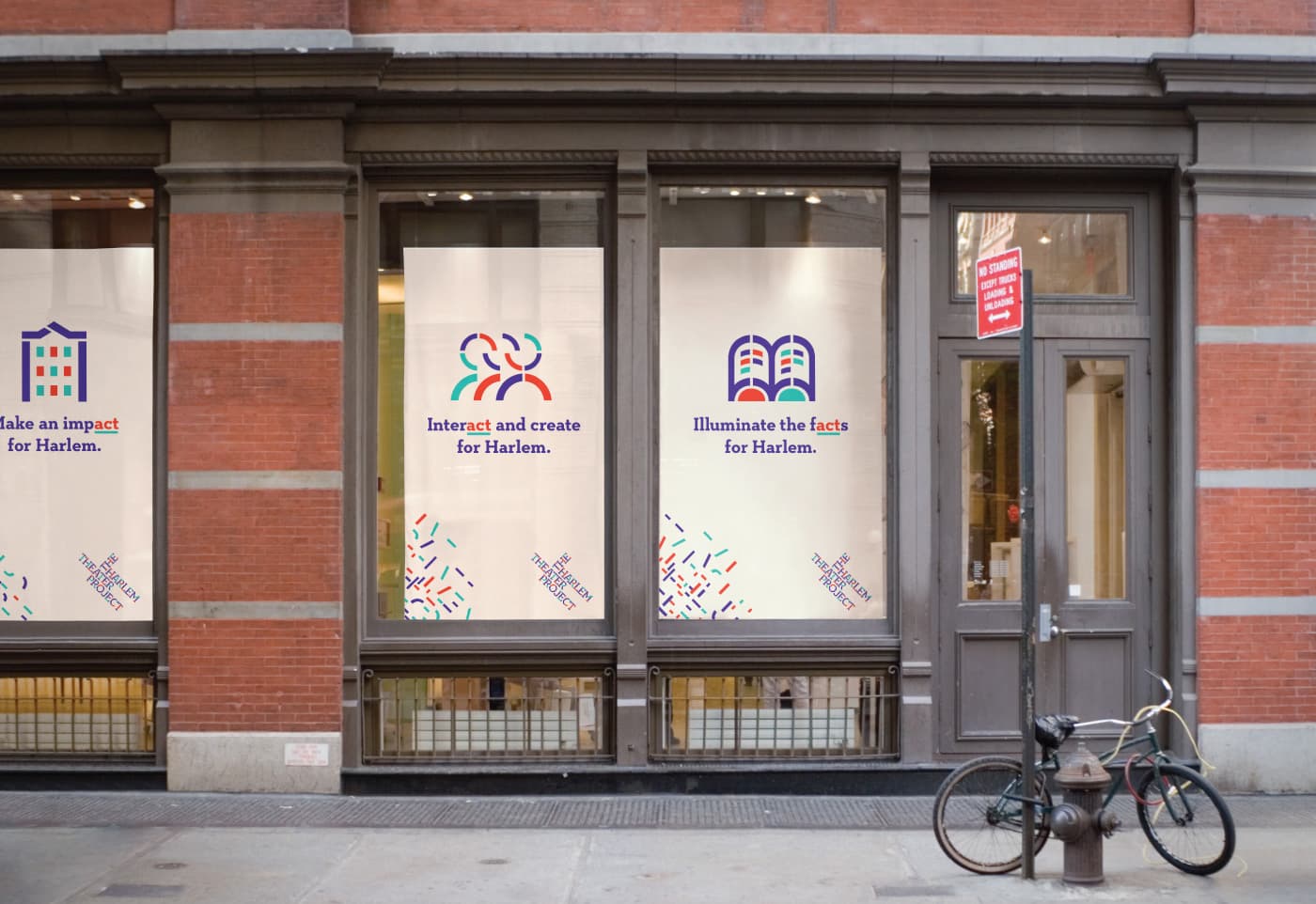 Storefront with three large windows displaying posters. Each poster has symbols and slogans. The left reads, "Make an impact for Harlem," the middle states, "Interact and create for Harlem," and the right says, "Illuminate the facts for Harlem." A bicycle is parked outside.