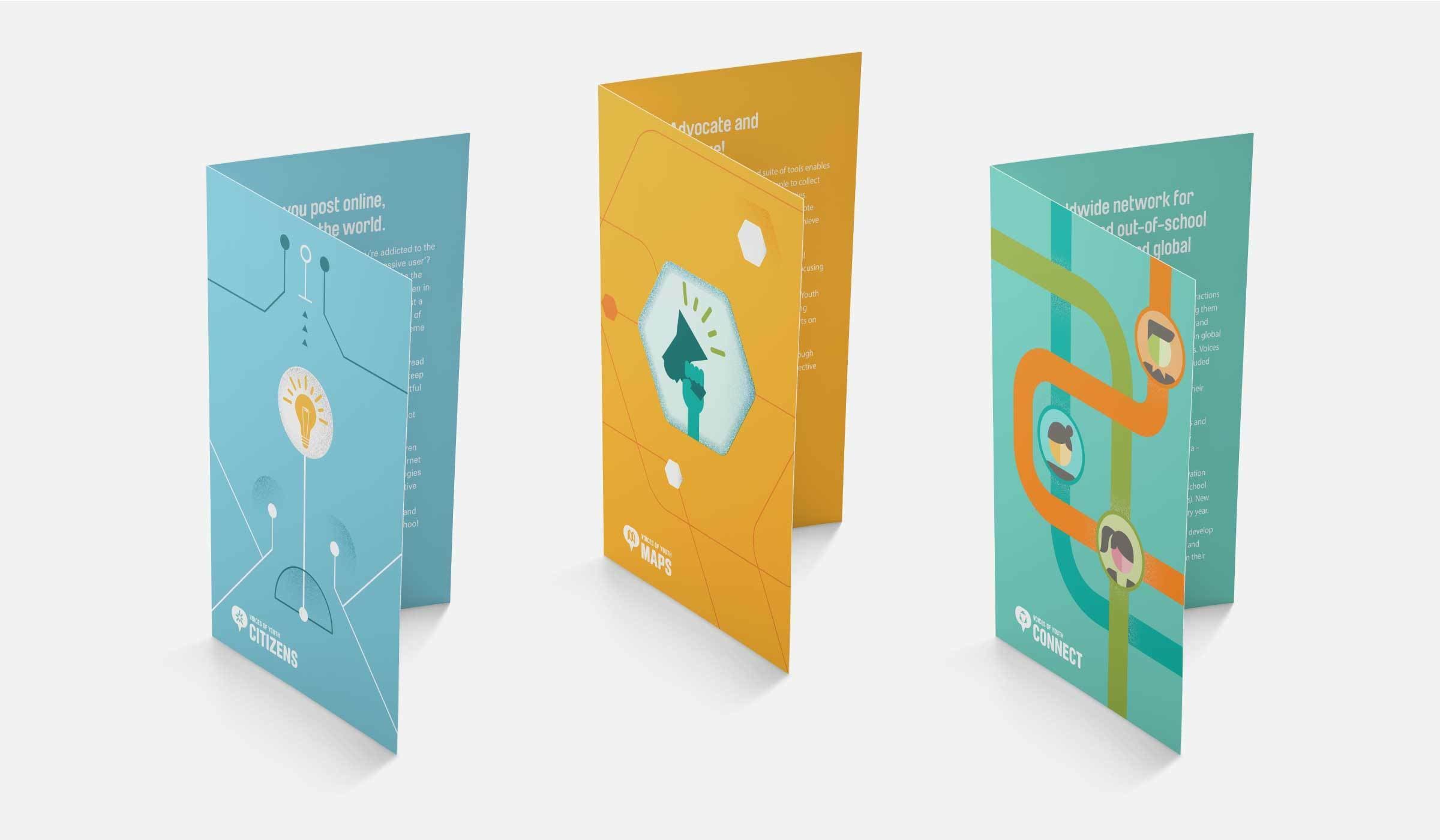 Three colorful foldable brochures stand open, showcasing intricate designs. The first brochure on the left features a lightbulb and circuit imagery. The middle brochure has a megaphone illustration. The right brochure presents a network diagram with circular icons.