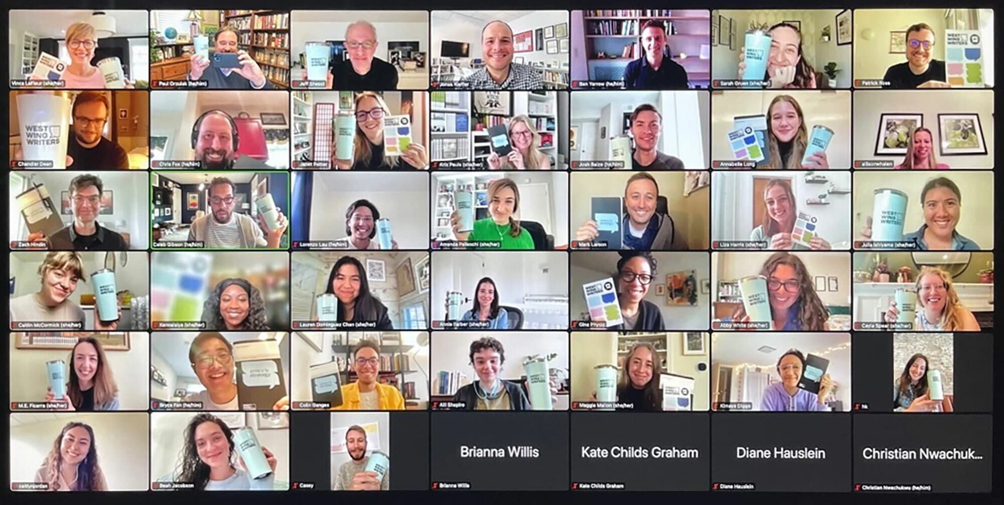 A screenshot of a Zoom meeting with over twenty participants, each holding a book with a similar cover. The attendees are smiling and appear in a grid layout, with their names shown underneath their video frames. The background varies for each participant.